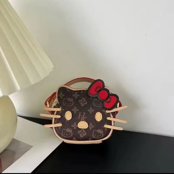 Hello Kitty Brown Monogram Mini Crossbody with Red Bow - Picture 1 of 4